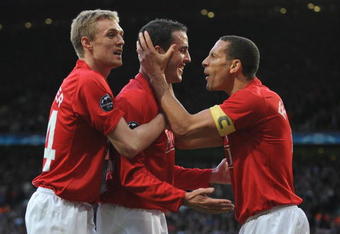 MANCHESTER, ENGLAND - APRIL 29:  John O' Shea of Manchester United is congratulated by his team mates after scoring the opening goal during the UEFA Champions League Semi Final First Leg match between Manchester United and Arsenal at Old Trafford on April 29, 2009 in Manchester, England.  (Photo by Shaun Botterill/Getty Images)