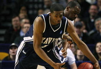 BOSTON - MARCH 26:  Sam Young #23 of the Pittsburgh Panthers and Derrick Brown #5 of the Xavier Musketeers fight to keep the ball in bounds during the NCAA Men's Basketball Tournament East Regionals at TD Banknorth Garden on March 26, 2009 in Boston, Massachusetts.  (Photo by Elsa/Getty Images)
