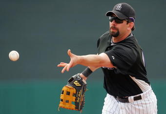 TUCSON, AZ - MARCH 05:  First baseman Todd Helton #17 of the Colorado Rockies under hands the ball to first base in the first inning during a spring training game against the Chicago White Sox at Hi Corbett Field on March 5, 2008 in Tucson, Arizona.  (Photo by Jeff Gross/Getty Images)