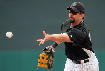 TUCSON, AZ - MARCH 05:  First baseman Todd Helton #17 of the Colorado Rockies under hands the ball to first base in the first inning during a spring training game against the Chicago White Sox at Hi Corbett Field on March 5, 2008 in Tucson, Arizona.  (Photo by Jeff Gross/Getty Images)