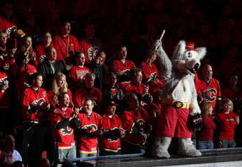 CALGARY, AB - APRIL 27: The Calgary Flames mascot 'Harvey the Hound'  leads fans in a cheer before the Flames played the Chicago Blackhawks  in Game Six of the Western Conference Quarterfinals of the 2009 Stanley Cup Playoffs on April 27, 2009 at the Pengrowth Saddledome in Calgary, Alberta, Canada. (Photo by Mike Ridewood/Getty Images)