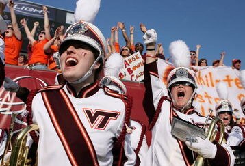 JACKSONVILLE, FL - DECEMBER 1:  The Virginia Tech band cheers on the field as the Virginia Tech Hokies tie the game just before half-time while taking on the Boston College Eagles in the ACC Championship Game at Jacksonville Municipal Stadium December 1, 2007 in Jacksonville, Florida. Virginia Tech defeated Boston College 30-16.  (Photo by Doug Benc/Getty Images)