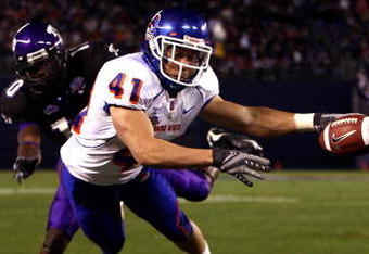 SAN DIEGO, CA - DECEMBER 23:  Runningback Ian Johnson #41 of the Boise State Broncos dives for the endzone pilon against the defense of Cornerback Rafael Priest #10 of TCU during the San Diego County Credit Union Poinsettia Bowl at Qualcomm Stadium on December 23, 2008 in San Diego, California. (Photo by Donald Miralle/Getty Images)