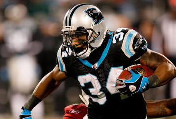 CHARLOTTE, NC - JANUARY 10:  DeAngelo Williams #34 of the Carolina Panthers runs against Gerald Hayes #54 of the Arizona Cardinals during the NFC Divisional Playoff Game on January 10, 2009 at Bank of America Stadium in Charlotte, North Carolina.  (Photo by Kevin C. Cox/Getty Images)