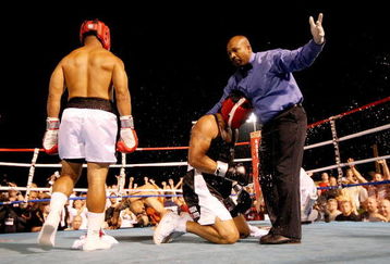 ATLANTIC CITY, NJ - JULY 12:  Referee Allan Huggins is hit with a can of beer as he stops the fight after former NFL player Via Sikahema knocked down former Major League Baseball player Jose Canseco in the first round during their celebrity boxing match on July 12, 2008 at Bernie Robbins Stadium in Atlantic City, New Jersey.  (Photo by Nick Laham/Getty Images)