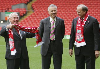 LIVERPOOL, UNITED KINGDOM - FEBRUARY 06:  Liverpool football club's new owners George Gillett (L), Tom Hicks (R) and chief executive Rick Parry (C) pose for photographs after their takeover on February 6, 2007, Liverpool, England. Gillett and  Hicks have reached a deal, thought to be worth GBP470m, to buy the football club.  (Photo by Christopher Furlong/Getty Images)