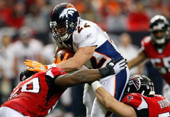 ATLANTA - NOVEMBER 16:  Fullback Peyton Hillis #22 of the Denver Broncos drives into Curtis Lofton #50 and Keith Brooking #56 of the Atlanta Falcons during the game at the Georgia Dome on November 16, 2008 in Atlanta, Georgia.  (Photo by Kevin C. Cox/Getty Images)