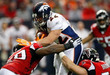 ATLANTA - NOVEMBER 16:  Fullback Peyton Hillis #22 of the Denver Broncos drives into Curtis Lofton #50 and Keith Brooking #56 of the Atlanta Falcons during the game at the Georgia Dome on November 16, 2008 in Atlanta, Georgia.  (Photo by Kevin C. Cox/Getty Images)