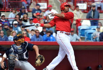 SARASOTA, FL - MARCH 1:  Outfielder Chris Dickerson #21 of the Cincinnati Reds follows through on a home run against the New York Yankees March 1, 2009 at Ed Smith Stadium in Sarasota, Florida.  (Photo by Al Messerschmidt/Getty Images)