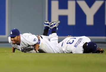 LOS ANGELES, CA - APRIL 30:  Matt Kemp #27 of the Los Angeles Dodgers reacts to his catch after diving over Orlando Hudson #13 for the third out against the San Diego Padres during the seventh inning at Dodger Stadium on April 30, 2009 in Los Angeles, California.  The Dodgers would win 8-5.  (Photo by Harry How/Getty Images)