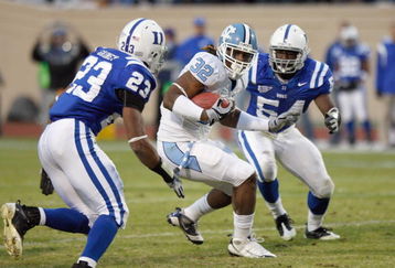 DURHAM, NC - NOVEMBER 29: Tailback Ryan Houston #32 of the North Carolina Tar Heels rushes against Catron Gainey #23 and Greg Akinbiyi #54 of the Duke Blue Devils during the game at Wallace Wade Stadium on November 29, 2008 in Durham, North Carolina. (Photo by Kevin C. Cox/Getty Images)
