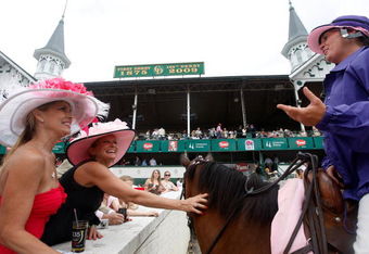 LOUISVILLE, KY - MAY 01:  Race fans pet the horse of a support rider prior to the 135th running of the Kentucky Oaks on May 1, 2009 at Churchill Downs in Louisville, Kentucky.  (Photo by Jamie Squire/Getty Images)