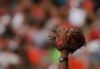 MIAMI - APRIL 06:  A fan holds up his glove to try and get a ball thrown his way by a player as the Washington Nationals take on the Florida Marlins on opening day at Dolphin Stadium on April 6, 2009 in Miami, Florida. The Marlins defeated the Nationals 12-5.  (Photo by Doug Benc/Getty Images)