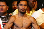 LAS VEGAS - MAY 01:  Manny Pacquiao of the Philippines poses after stepping on the scale at 138 pounds during the weigh-in for his junior welterweight title fight against Ricky Hatton of England at the MGM Grand Garden Arena May 1, 2009 in Las Vegas, Nevada.  (Photo by Al Bello/Getty Images)