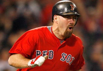 BOSTON - APRIL 24: Kevin Youkilis #20 of the Boston Red Sox hits a game-winning home run in the 11th inning against the New York Yankees at Fenway Park, April 24, 2009, in Boston, Massachusetts. (Photo by Jim Rogash/Getty Images)