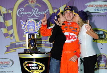 RICHMOND, VA - MAY 02:  Kyle Busch, driver of the #18 Combos Toyota, celebrates in victory lane with his  girlfriend Samantha Sarcinella (L) after winning the NASCAR Sprint Cup Series Crown Royal Presents the Russ Friedman 400 at Richmond International Raceway on May 2, 2009 in Richmond, Virginia.  (Photo by John Harrelson/Getty Images)