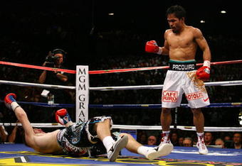 LAS VEGAS - MAY 02:  (R-L) Manny Pacquiao of the Philippines stands over Ricky Hatton of England after Pacquiao knocked him out in the second round during their junior welterweight title fight at the MGM Grand Garden Arena May 2, 2009 in Las Vegas, Nevada.  (Photo by Al Bello/Getty Images)