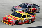 BRISTOL, TN - MARCH 22: Marcos Ambrose, driver of the #47 Little Debbie/Clorox/Kingsford Toyota, races Scott Speed, driver of the #82 Red Bull Toyota, during the NASCAR Sprint Cup Series Food City 500 at Bristol Motor Speedway on March 22, 2009 in Bristol, Tennessee.  (Photo by Geoff Burke/Getty Images for NASCAR)