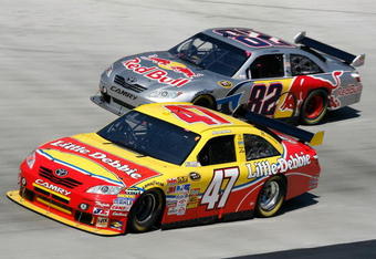 BRISTOL, TN - MARCH 22: Marcos Ambrose, driver of the #47 Little Debbie/Clorox/Kingsford Toyota, races Scott Speed, driver of the #82 Red Bull Toyota, during the NASCAR Sprint Cup Series Food City 500 at Bristol Motor Speedway on March 22, 2009 in Bristol, Tennessee.  (Photo by Geoff Burke/Getty Images for NASCAR)