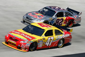 BRISTOL, TN - MARCH 22: Marcos Ambrose, driver of the #47 Little Debbie/Clorox/Kingsford Toyota, races Scott Speed, driver of the #82 Red Bull Toyota, during the NASCAR Sprint Cup Series Food City 500 at Bristol Motor Speedway on March 22, 2009 in Bristol, Tennessee.  (Photo by Geoff Burke/Getty Images for NASCAR)