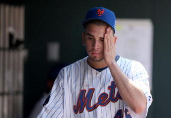 NEW YORK - APRIL 26:  Oliver Perez #46 of the New York Mets reacts in the dugout after he was taken out of their game against the Washington Nationals in the fifth inning on April 26, 2009 at Citi Field in the Flushing neighborhood of the Queens borough of New York City.  (Photo by Ezra Shaw/Getty Images)