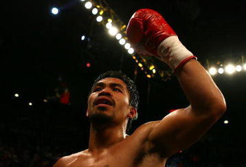 LAS VEGAS - MAY 02:  Manny Pacquiao of the Philippines reacts after knocking down Ricky Hatton of England in the second round during their junior welterweight title fight at the MGM Grand Garden Arena May 2, 2009 in Las Vegas, Nevada.  (Photo by Al Bello/Getty Images)