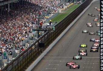 INDIANAPOLIS - MAY 25:  Scott Dixon, driver of the #9 Target Chip Ganassi Racing Dallara Honda, leads the pack with teammate Dan Wheldon, driver of the #10 Target Chip Ganassi Racing Dallara Honda, at the final re-start during the IRL IndyCar Series 92nd running of the Indianapolis 500 at Indianapolis Motor Speedway on May 25, 2008 in Indianapolis, Indiana. (Photo by Donald Miralle/Getty Images)