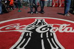SAN FRANCISCO - APRIL 16:  San Francisco Giants fans walk by a large Coca Cola logo during a baseball game April 16, 2008 at AT&T Park in San Francisco, California. Atlanta-based Coca Cola reported today that profits for the first quarter increased 19 percent to $1.50 billion, or 64 cents a share comapred to  $1.26 billion, or 54 cents a share one year ago  (Photo by Justin Sullivan/Getty Images)