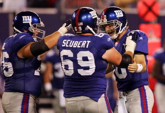 EAST RUTHERFORD, NJ - AUGUST 18:  Eli Manning #10 of the New York Giants is congratulated by teammates Rich Seubert #69 and Chris Snee #76 after he threw his second touchdown against the Cleveland Browns on August 18, 2008 at Giants Stadium in East Rutherford, New Jersey.  (Photo by Jim McIsaac/Getty Images)