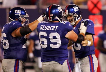 EAST RUTHERFORD, NJ - AUGUST 18:  Eli Manning #10 of the New York Giants is congratulated by teammates Rich Seubert #69 and Chris Snee #76 after he threw his second touchdown against the Cleveland Browns on August 18, 2008 at Giants Stadium in East Rutherford, New Jersey.  (Photo by Jim McIsaac/Getty Images)
