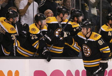 BOSTON - MAY 01:  Marc Savard #91 of the Boston Bruins is congratulated by teammates on the bench after he scored a goal against the Carolina Hurricanes during Game One of the Eastern Conference Semifinal Round of the 2009 Stanley Cup Playoffs on May 1, 2009 at the TD Banknorth Garden in Boston, Massachusetts. The Bruins defeated the Hurricanes 4-1.  (Photo by Elsa/Getty Images)