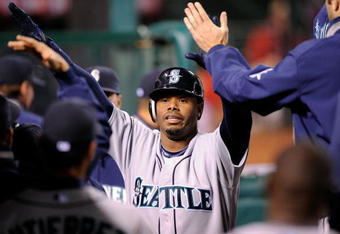ANAHEIM, CA - APRIL 25:  Ken Griffey Jr. #24 of the Seattle Mariners is congratulated in the dugout after scoring on a base hit by Russell Branyan #30 against the Los Angeles Angels of Anaheim during the seventh inning of the baseball game on April 25, 2009 at Angel Stadium in Anaheim, California.  (Photo by Kevork Djansezians/Getty Images)