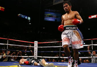 LAS VEGAS - MAY 02:  (R-L) Manny Pacquiao of the Philippines stands over Ricky Hatton of England after Pacquiao knocked him out in the second round during their junior welterweight title fight at the MGM Grand Garden Arena May 2, 2009 in Las Vegas, Nevada.  (Photo by Al Bello/Getty Images)