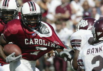 COLUMBIA, SC - OCTOBER 5:  Michael Ages #7 of USC is pulled down by his jersey by a Mississippi State defender during the NCAA football game at Williams-Brice Stadium in Columbia, South Carolina on October 5, 2002.  The University of South Carolina Gamecocks defeated the Mississippi State Bulldogs 34-10.  (Photo by Craig Jones /Getty Images) 