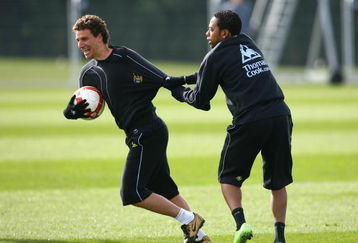 MANCHESTER, UNITED KINGDOM - MARCH 11:  Robinho of Manchester City jokes around with team mate Elano during a training session, ahead of their UEFA Cup match against Aalborg, held at the Carrington Training Complex on March 11, 2009 in Manchester, England.  (Photo by Alex Livesey/Getty Images)