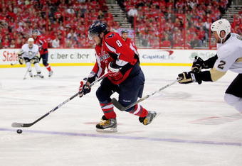 WASHINGTON - MAY 04:  Alex Ovechkin #8 of the Washington Capitals skates the puck past Hall Gill #2 of the Pittsburgh Penguins during Game Two of the Eastern Conference Semifinal Round of the 2009 Stanley Cup Playoffs on May 4, 2009 at the Verizon Center in Washington,  DC.  (Photo by Len Redkoles/Getty Images)