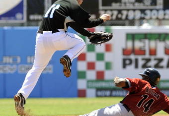 DUNEDIN, FL - MARCH 27:  Shortstop David Eckstein #11 of the Toronto Blue Jays leaps over sliding outfielder Michael Bourn #14 of the Houston Astros at Knology Park March 27, 2008 in Dunedin, Florida.  (Photo by Al Messerschmidt/Getty Images)