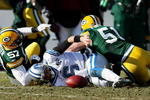 GREEN BAY, WI - DECEMBER 28: Dan Orlovsky #6 of the Detroit Lions looses the ball after being tackled by Jason Hunter #57 and Brady Poppinga #51 of the Green Bay Packers on December 28, 2008 at Lambeau Field in Green Bay, Wisconsin. The Packers defeated the Lions 31-21. (Photo by Jonathan Daniel/Getty Images)
