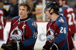 DENVER - NOVEMBER 26:  Joe Sakic #19 and Paul Stastny #26 of the Colorado Avalanche chat during warm ups prior to facing the St. Louis Blues during NHL action at the Pepsi Center November 26, 2008 in Denver, Colorado.  (Photo by Doug Pensinger/Getty Images)