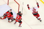 NEWARK, NJ - APRIL 28:   Eric Staal #12 of the Carolina Hurricanes celebrates after his game-winning goal at 19:28 in the third period against goaltender Martin Brodeur #30 and Mike Mottau #27 of the New Jersey Devils during Game Seven of the Eastern Conference Quarterfinal Round of the 2009 Stanley Cup Playoffs at the Prudential Center on April 28, 2009 in Newark, New Jersey. Tghe Hurricanes defeat the Devils 4-3  (Photo by Mike Stobe/Getty Images)