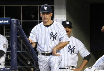 NEW YORK - APRIL 18: Manager of the New York Yankees, Joe Girardi #27 watches on from the dugout against of the Cleveland Indians at Yankee Stadium on April 18, 2009 in the Bronx borough of New York City. (Photo by Nick Laham/Getty Images)