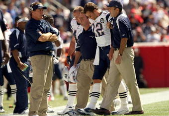 FOXBORO, MA - SEPTEMBER 7:  Quarterback Tom Brady #12 of the New England Patriots walks off the field with the aid of the Patriots staff after being injured on a play during their NFL game against the Kansas City Chiefs on September 7, 2008 at Gillette Stadium in Foxboro, Massachusetts. The Patriots defeated the Chiefs 17-10. (Photo by Elsa Garrison/Getty Images)