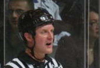 TORONTO - JANUARY 15:  Linesman Greg Devorski and referees Brad Watson and Kevin Pollock have a meeting during the Carolina Hurricanes game against the Toronto Maple Leafs at Air Canada Centre on January 15, 2008 in Toronto, Ontario. (Photo by Dave Sandford/Getty Images)