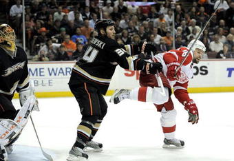 ANAHEIM, CA - MAY 05:  Goaltender Jonas Hiller #1 and James Wisniewski #34  of the Anaheim Ducks defend the goals against Tomas Holmstrom #96 of the Detroit Red Wings during Game Three of the Western Conference Semifinal Round of the 2009 Stanley Cup Playoffs at the Honda Center on May 5, 2009 in Anaheim, California. (Photo by Kevork Djansezianl/Getty Images)