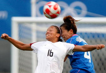 QINHUANGDAO, CHINA - AUGUST 09:  Angela Hucles (L) of the United States and Azusa Iwashimizu of Japan compete for the ball during the Women's Group G match between Japan and USA on Day 1 of the Beijing 2008 Olympic Games on August 9, 2008 in Qinhuangdao, China.  (Photo by Noriko Hayakusa/Getty Images)