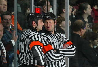 UNIONDALE, NY - APRIL 04:  Referees Francois St-Laurent and Steve Kozari talking during a break in action between the Tampa Bay Lightning and the New York Islanders in a National Hockey League game at Nassau Coliseum on April 4, 2009 in Uniondale, New York. (Photo by Paul Bereswill/Getty Images)