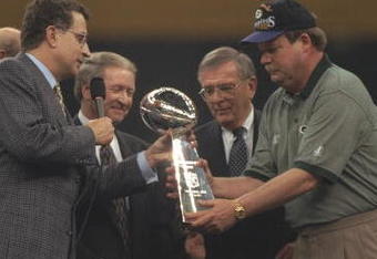 26 Jan 1997:  Head coach Mike Holmgren of the Green Bay Packers (right) receives the Vince Lombardi trophy from NFL commissioner Paul Tagliabue (left) after the Packers beat the New England Patriots 35-21 to win Super Bowl XXXI at the Louisiana Superdome