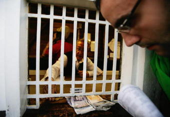LONDON - AUGUST 14:  A man places a bet at the Tote at Walthamstow Greyhound Stadium on August 14, 2008 in London, England. The  famous Walthamstow Greyhound Stadium is set to run its last race on saturday night after 75 years of racing. The east London track which has hosted famous people from Winston Churchill to Brad Pitt, has been sold to property developers due to falling profits and poor attendance.  (Photo by Daniel Berehulak/Getty Images)