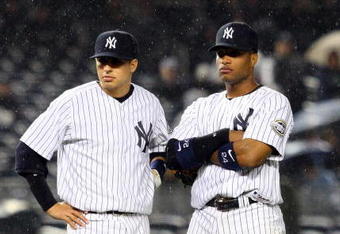 NEW YORK - MAY 05:  Ramiro Pena #19 and Robinson Cano #24 of the New York Yankees looks on against the Boston Red Sox on May 5, 2009 at Yankee Stadium in the Bronx borough of New York City.  (Photo by Jim McIsaac/Getty Images)