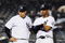 NEW YORK - MAY 05:  Ramiro Pena #19 and Robinson Cano #24 of the New York Yankees looks on against the Boston Red Sox on May 5, 2009 at Yankee Stadium in the Bronx borough of New York City.  (Photo by Jim McIsaac/Getty Images)